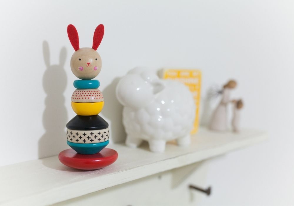 A few children's toys sitting on a white shelf