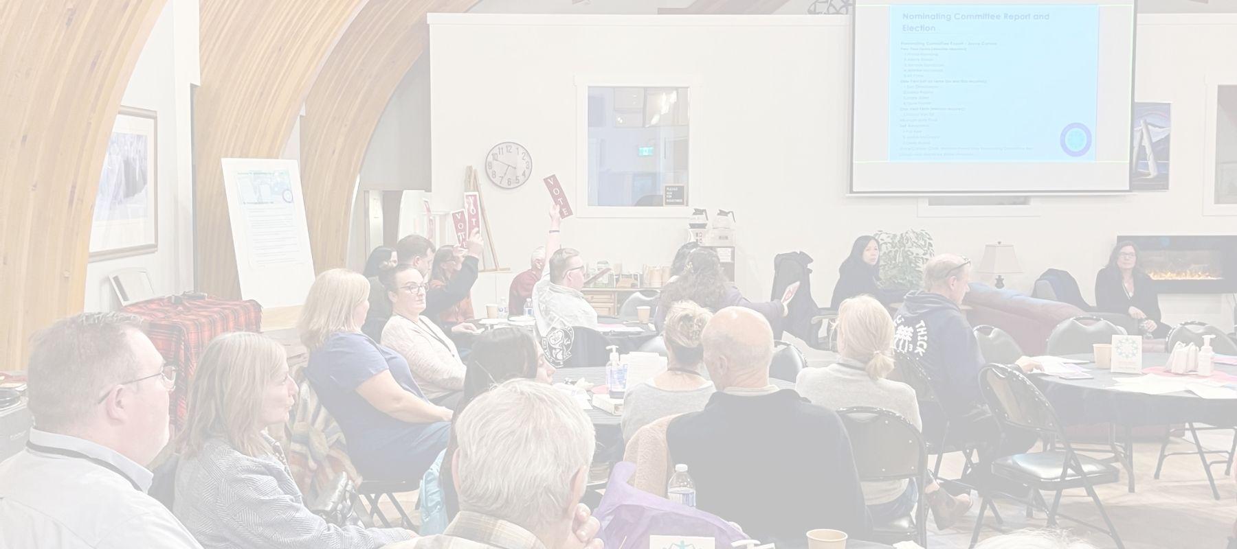 People voting at inclusion powell river's AGM