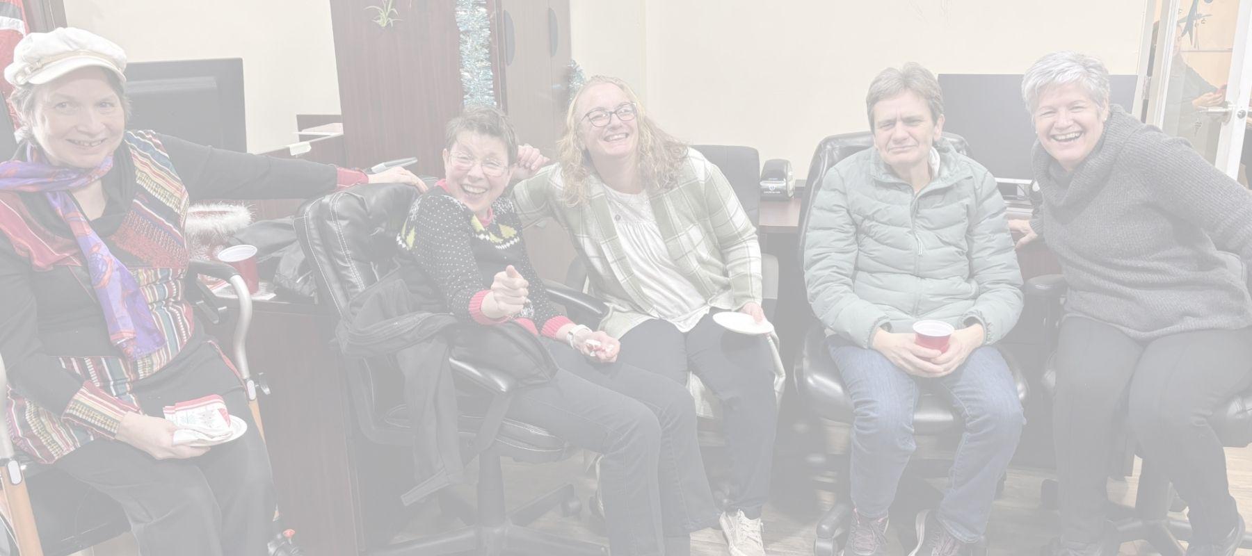 People laughing and having fun at inclusion powell river's Christmas open house. 