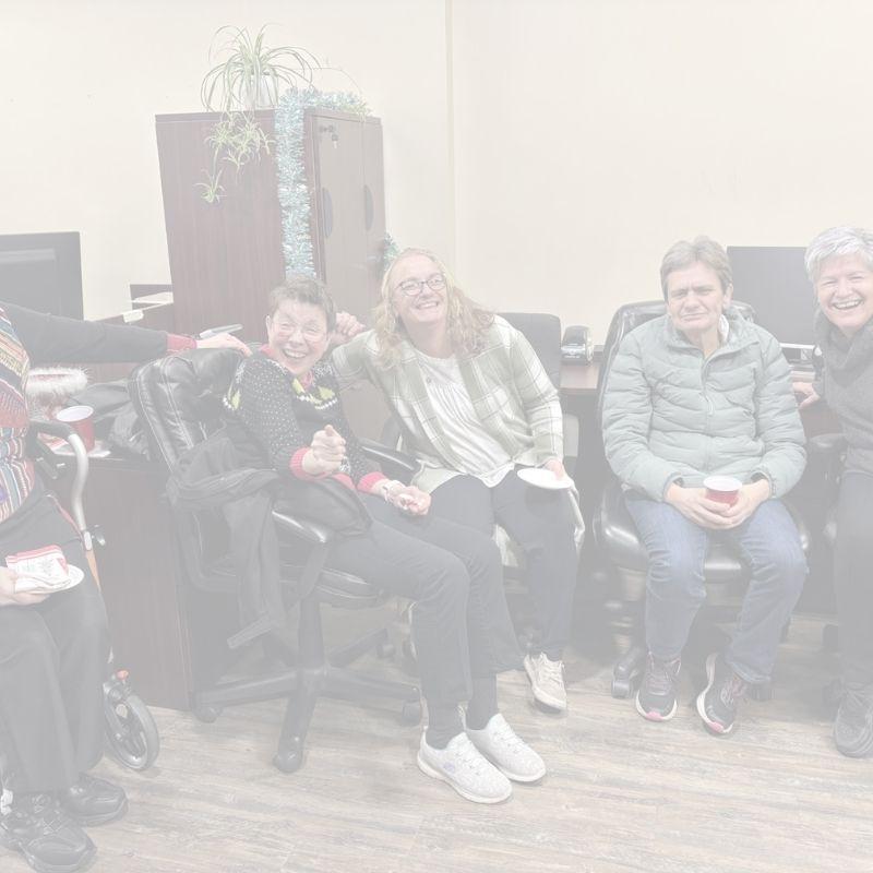 People laughing and having fun at inclusion powell river's Christmas open house. 
