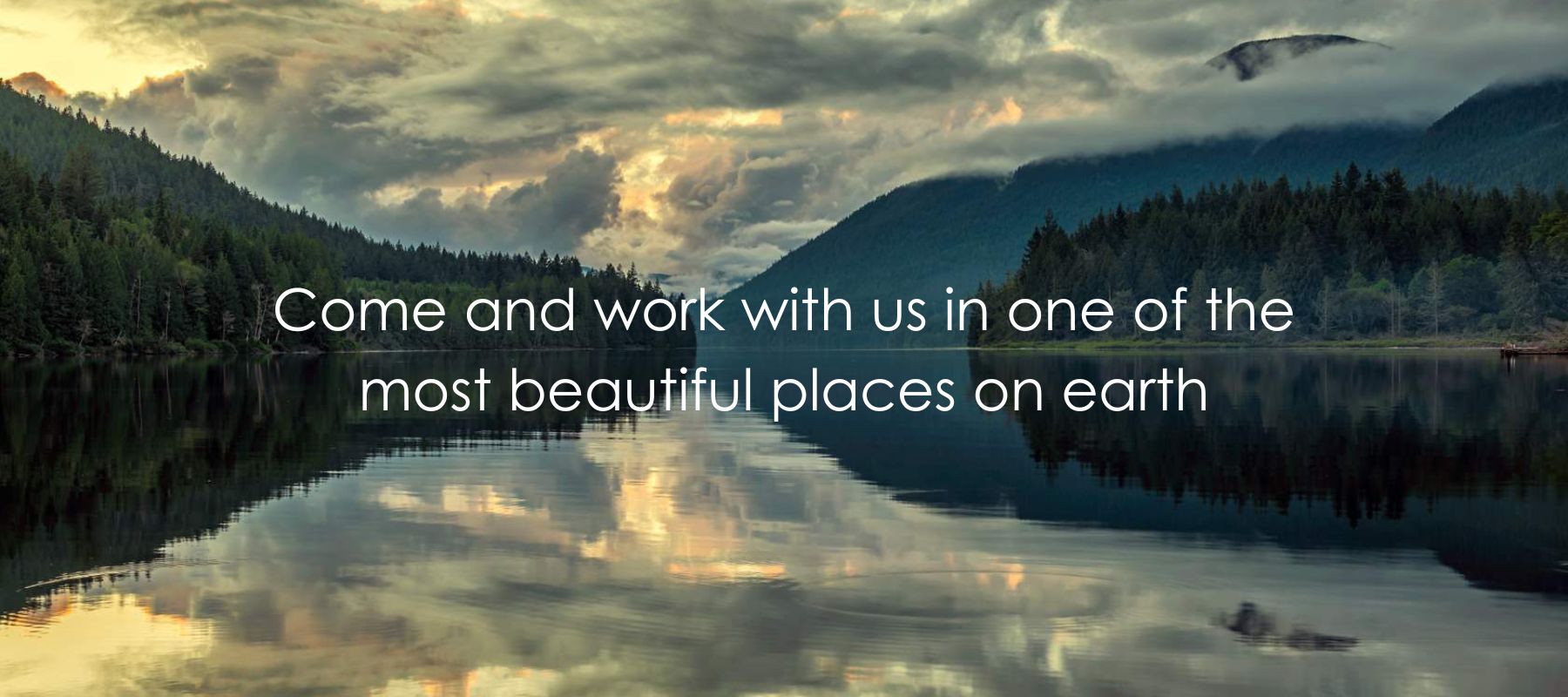Photo of a lake with the reflection of the surrounding mountains in qathet sunshine coast